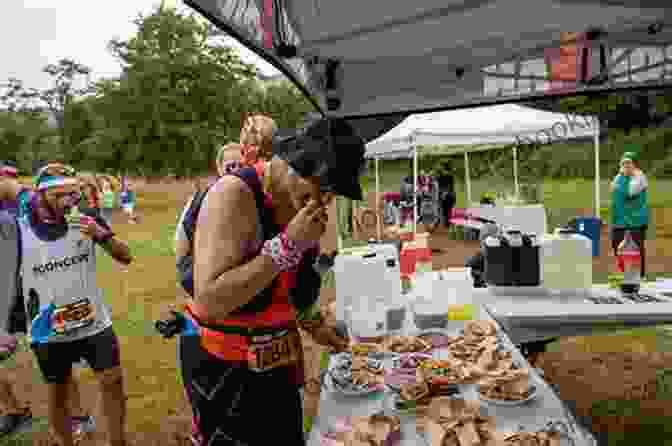 A Runner Replenishing Carbohydrates And Electrolytes At An Aid Station During An Ultramarathon, Highlighting The Significance Of Nutrition During These Events. Hal Koerner S Field Guide To Ultrarunning: Training For An Ultramarathon From 50K To 100 Miles And Beyond