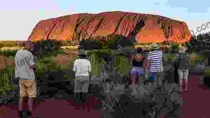 A Woman Standing In Front Of Uluru (Ayers Rock) Diary Of A Shy Backpacker: Awakening Down Under